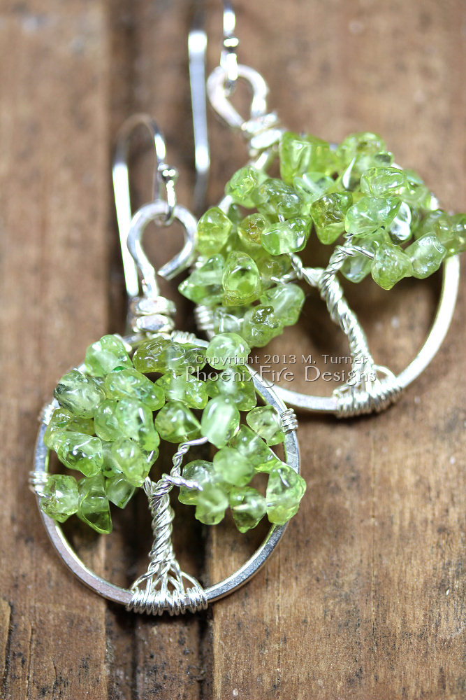 This pair of dainty Tree of Life earrings features genuine, natural Peridot gemstones and hangs on .925 sterling silver French ear wire hooks. Artisan original jewelry handmade by Miss M. Turner of PhoenixFire Designs 