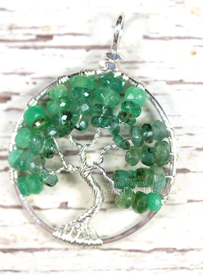 Stunning shaded ombre emerald rondelles in silver wire make up this handcrafted, wire wrapped Tree of Life Pendant featuring May's precious gemstone birthstone.