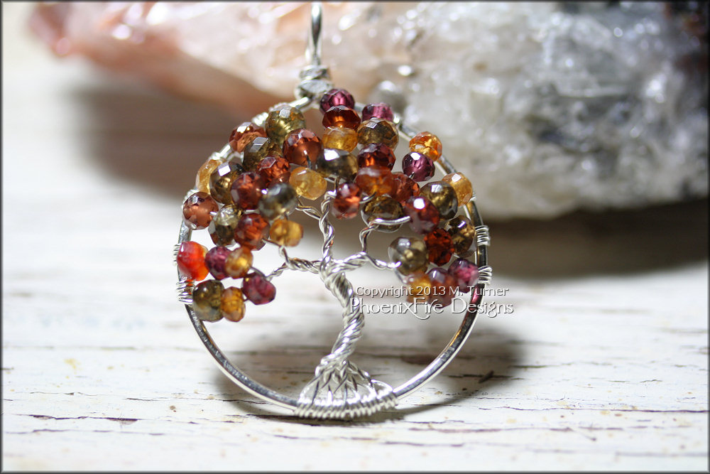 Stunning Tunduru (Tundra) Sapphire in an Autumn range of red, orange, green and plum make up this gorgeous Tree of Life Pendant in non tarnish silver wire.