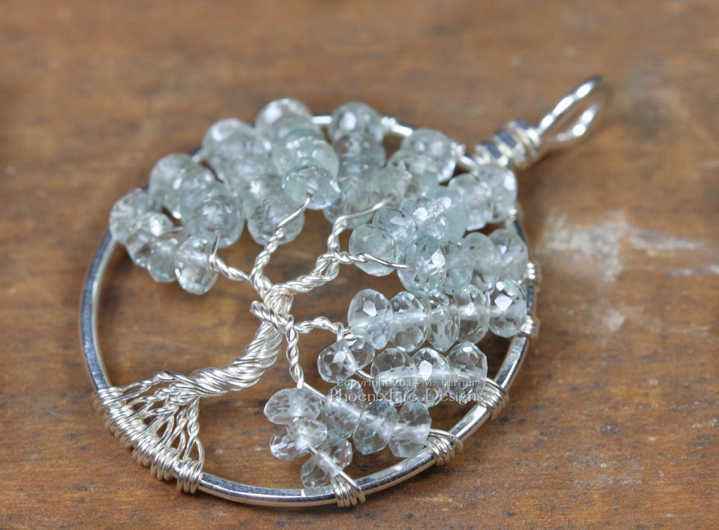 Tree of Life Pendant in striking pale blue faceted aquamarine rondelles wire wrapped in non-tarnish silver wire forming a handmade pendant in the icy birthstone of March. Handmade wire wrap by Miss M. Turner of PhoenixFire Designs on etsy.