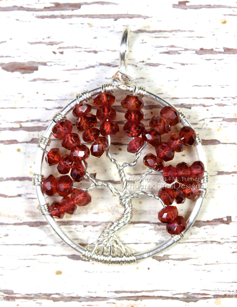 Handcrafted Birthstone Jewelry Tree of Life Pendant wire wrapped in silver wire featuring January's birthstone, Garnet as micro faceted rondelles. By PhoenixFire Designs on Etsy.