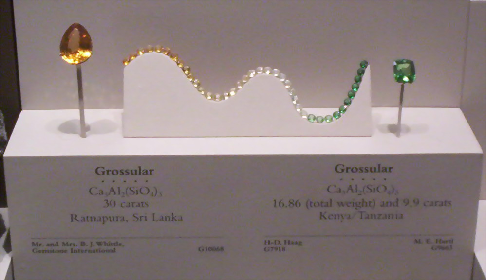 Color range of Grossular garnets on display at the U.S. National Museum of Natural History. The green gem at right is a type of grossular known as tsavorite.