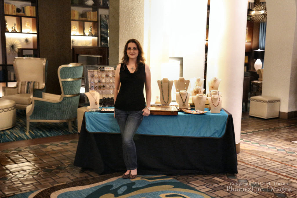 Jewelry Artist Miss M. Turner of PhoenixFire Designs stands in front of the local artisan showcase at the Vinoy Resort, St. Petersburg July 24, 2015