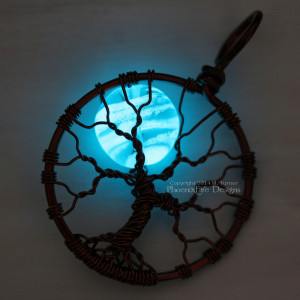Glowing blue moon glow in the dark tree of life pendant, wire wrapped in your choice of wire by PhoenixFire Designs. This glow in the dark necklace truly glows and is also UV and blacklight reactive.