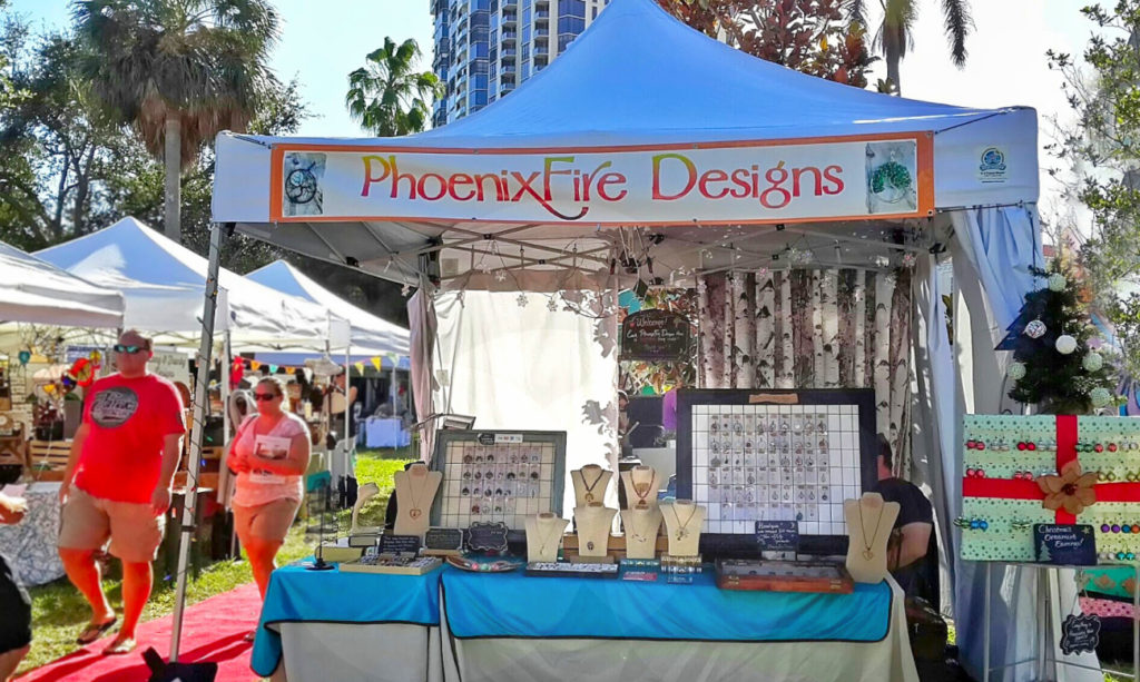 PhoenixFire Designs handmade, wire wrapped jewelry tree of life pendant necklaces, celestial jewelry and more vendor booth at Shopapalooza Festival south straub park downtown st petersburg. Shop small, shop local!