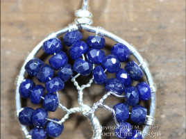 Stunning blue sapphire micro-faceted rondelles are set in sterling silver wire to form a beautiful Tree of Life pendant. Precious sapphire is the birthstone of September.