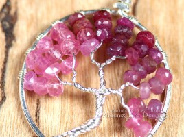 Stunning shaded ombre red, raspberry and pink ruby rondelles in silver wire make up this Tree of Life Pendant featuring July's precious gemstone birthstone.