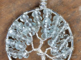 Tree of Life Pendant in striking pale blue faceted aquamarine rondelles wire wrapped in non-tarnish silver wire forming a handmade pendant in the icy birthstone of March. Handmade by Miss M Turner of PhoenixFire Deisgns on etsy.