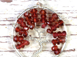 Handcrafted Birthstone Jewelry Tree of Life Pendant wire wrapped in silver wire featuring January's birthstone, Garnet as micro faceted rondelles. By PhoenixFire Designs on Etsy.