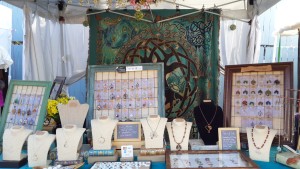 Handcrafted gemstone jewelry and wire wrapped tree of life pendants by PhoenixFire Designs craft show booth display at the Bay Area Renaissance Festival March 2015