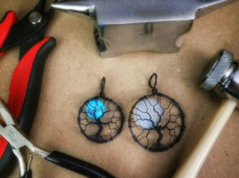 Blue glow in the dark full moon tree of life and opalite moonstone tree of life handmade wire wrap pendants fresh off the PhoenixFire Designs workbench